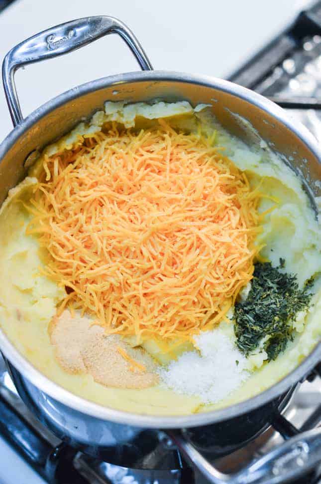 Cheese, garlic powder, parsley and salt ready to be mixed into potatoes