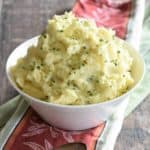 Mashed potatoes in a bowl garnished with chives