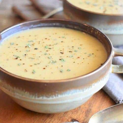 close-up of soup in a rustic bowl with another one partially in view behind it