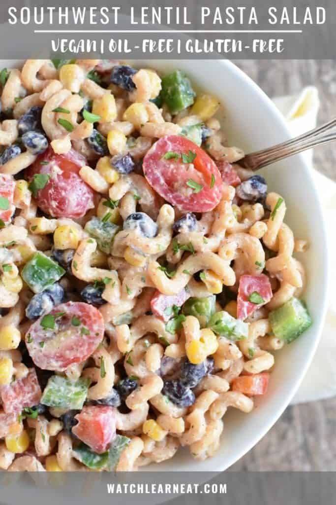 pin showing pasta salad in white bowl with spoon in it