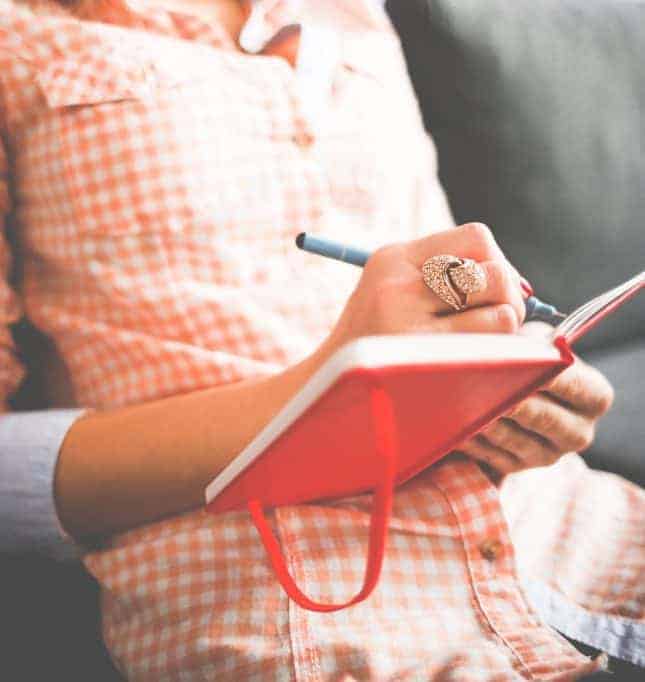 person writing in a journal