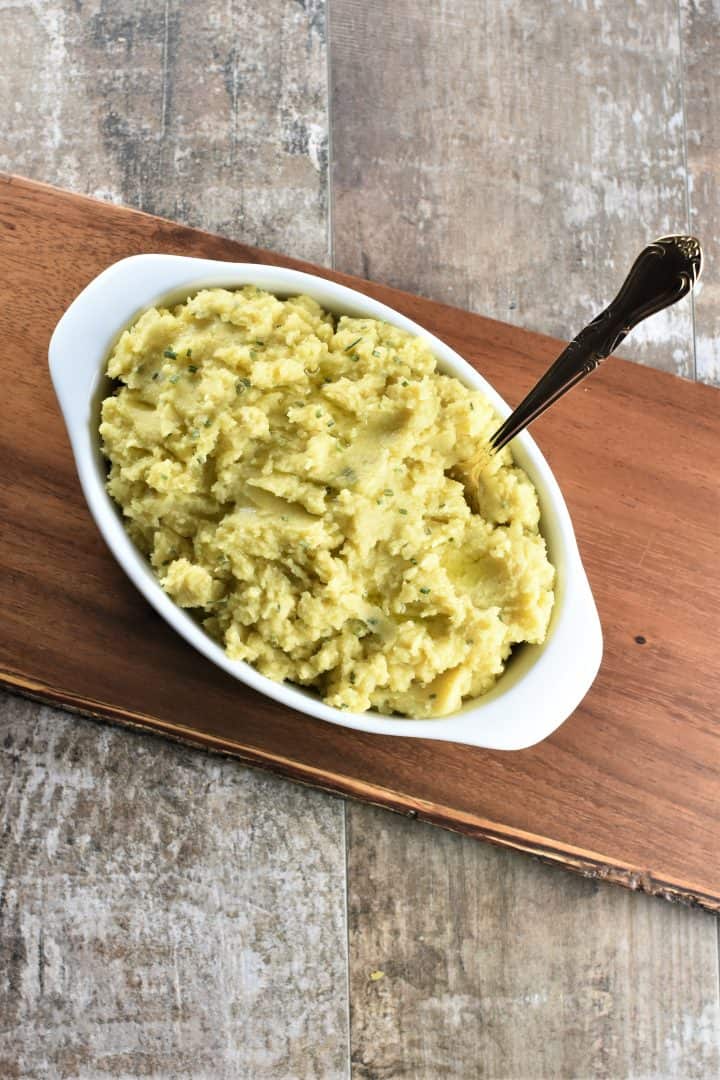 overhead of mashed potatoes in white bowl with a spoon