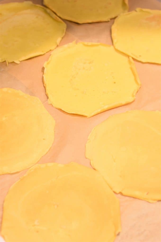 Cooked manicotti shells (crepes) placed separately on parchment paper