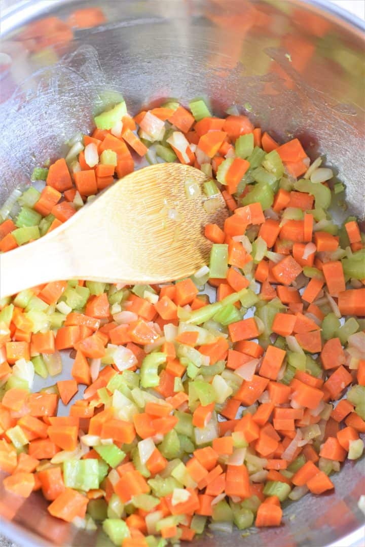 Cooking carrots, celery, onions and garlic in a soup pot