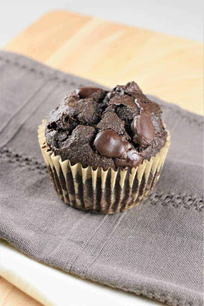 vegan double chocolate chip muffin on a kitchen towel