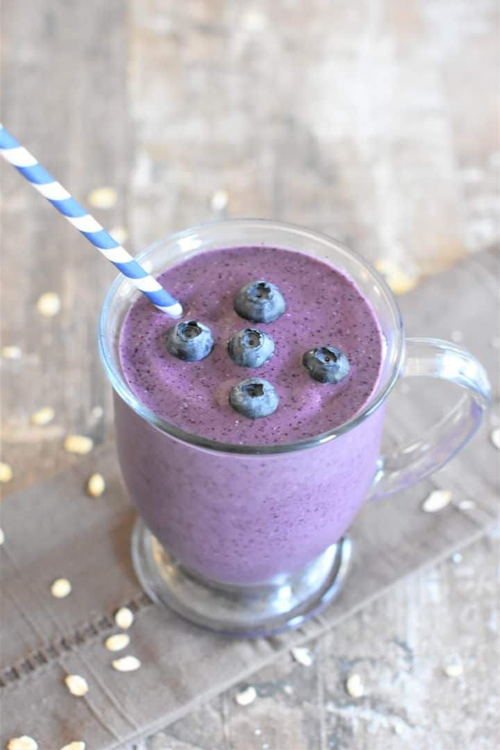 Blueberry Pie Smoothie in a glass mug with a straw