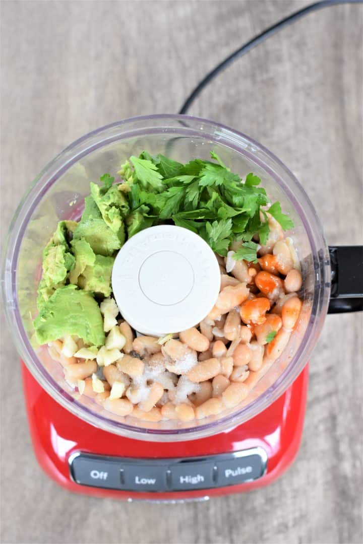 Ingredients for hummus in a food processor before blending