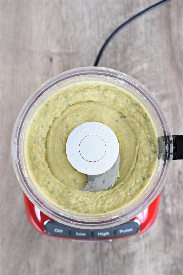 overhead of hummus in a red food processor