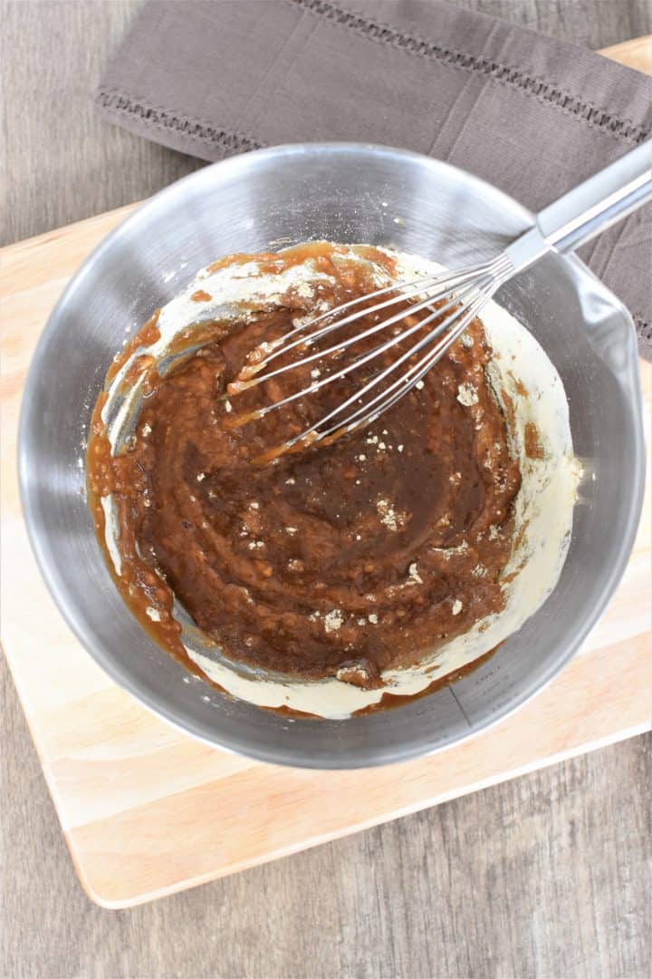 whisking together wet and dry ingredients in mixing bowl