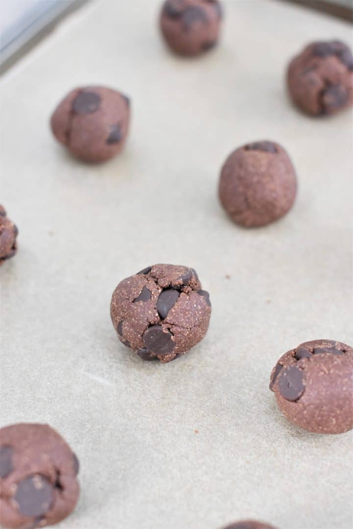 cookie bites on parchment on baking sheet after freezing