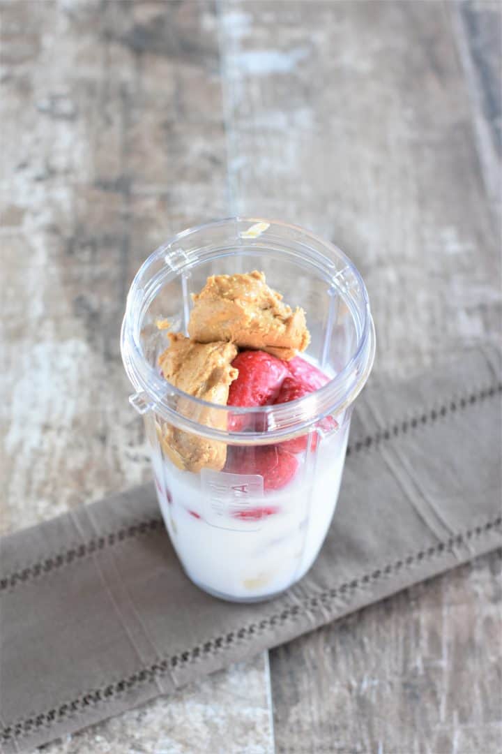 Strawberry and peanut butter in a blender cup