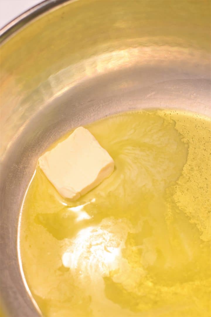 Butter melting in a pan with olive oil