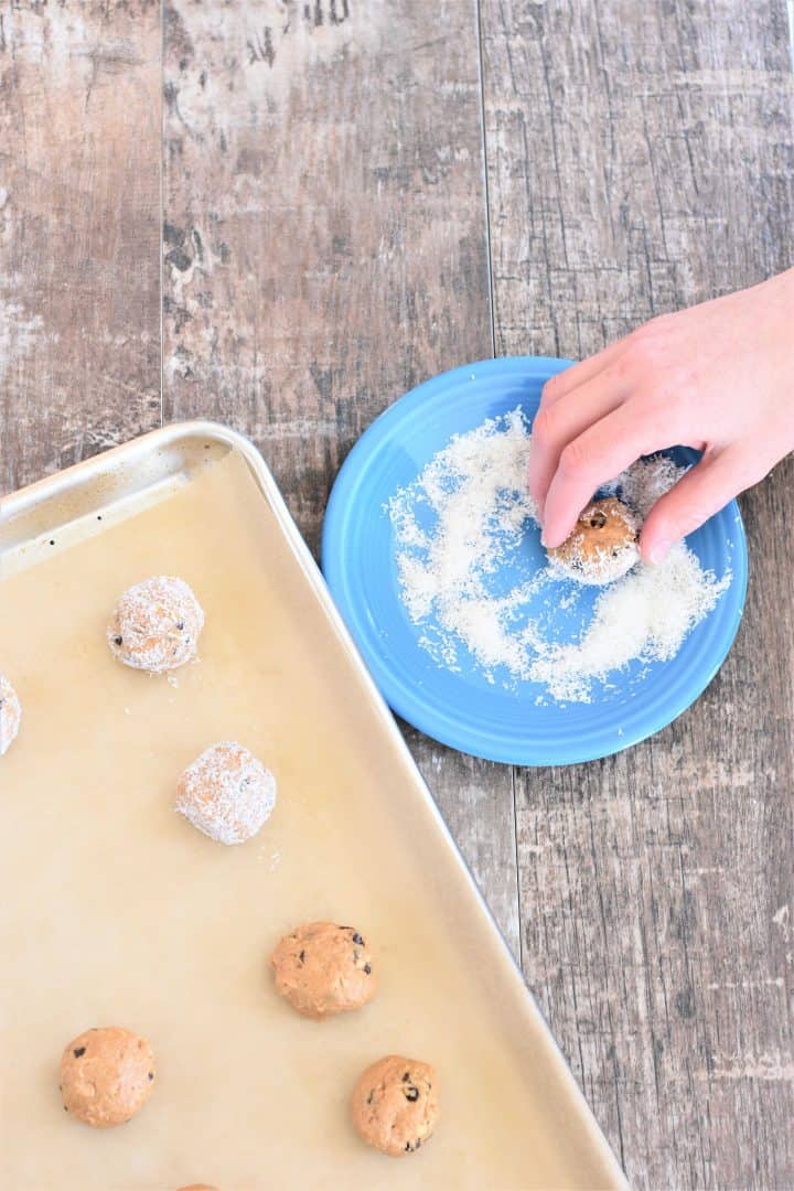 Rolling peanut butter balls in shredded coconut