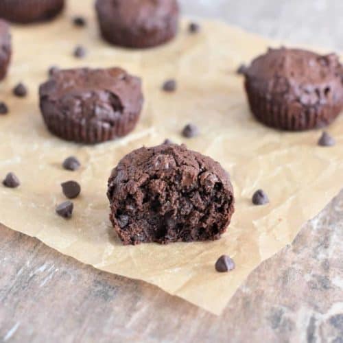 mini brownies on parchment with bite taken out of one