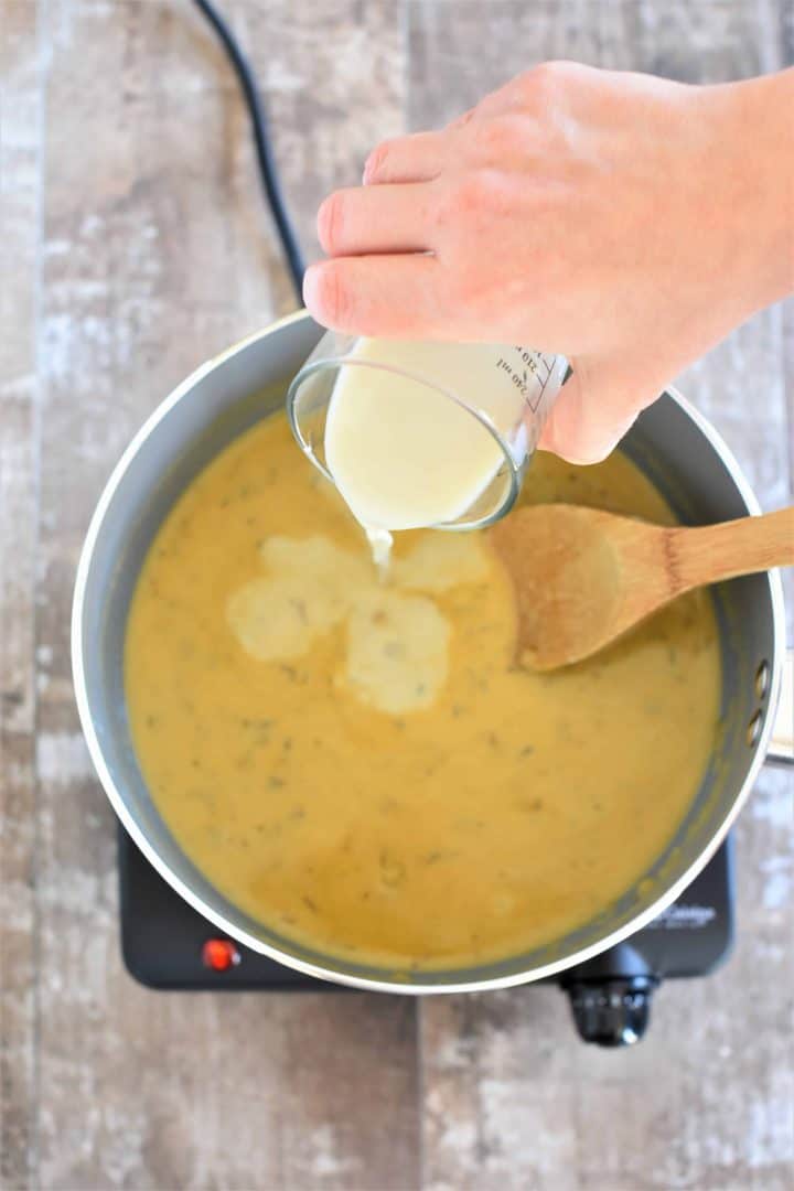 Oat milk being poured into saucepan