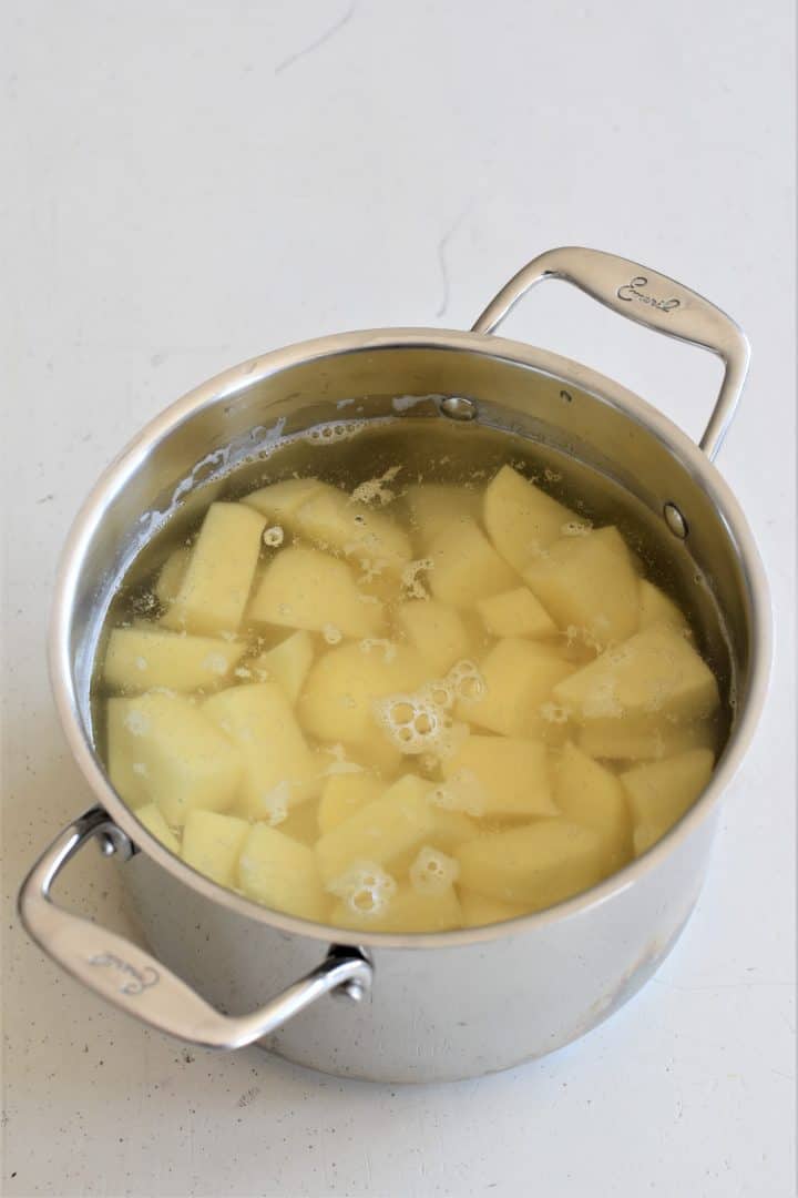 potatoes in a pot with water covering them