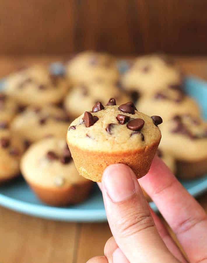 Closeup of a mini muffin with muffins on a plate in the background