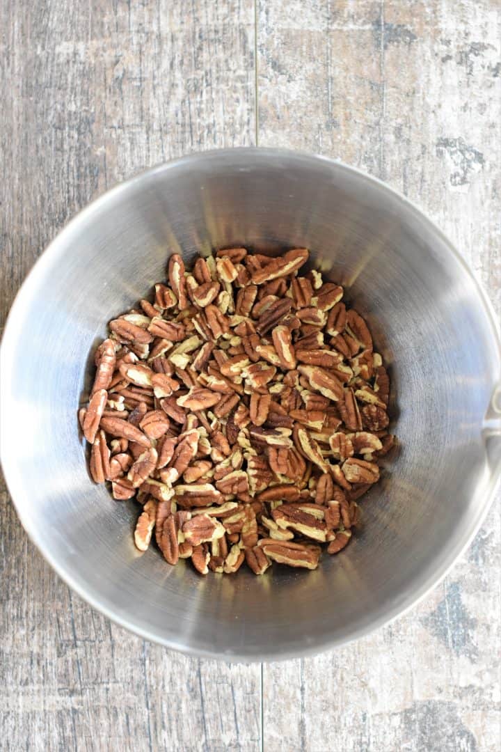 raw pecans in a mixing bowl