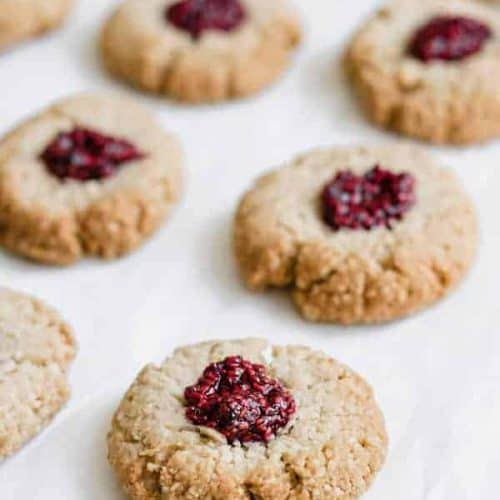 thumbprint cookies on white parchment