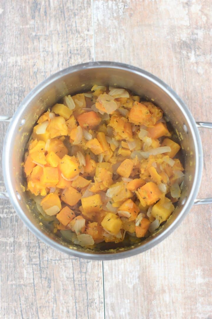 vegetable broth added to the ingredients in the soup pot