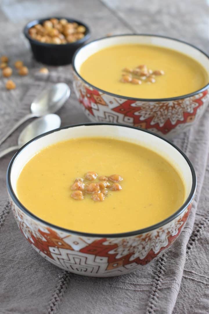 finished soup in two bowls topped with chickpeas