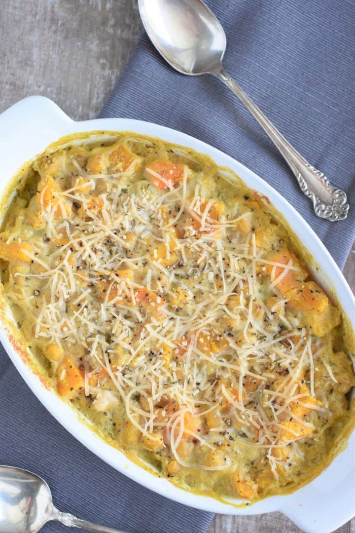 Overhead view of baked casserole on napkin with one spoon in front and other in back