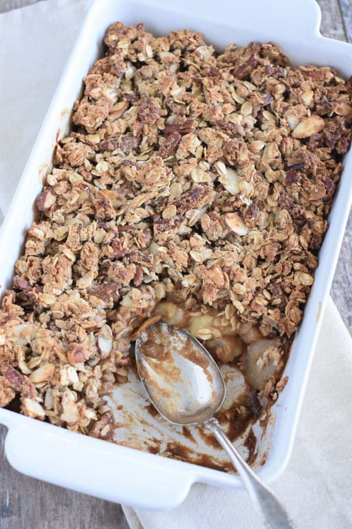 Spoon in baking dish with some of the dessert taken out