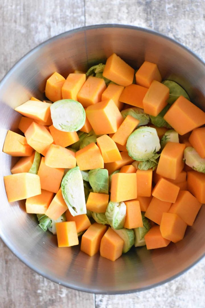 Butternut squash and Brussels sprouts in a mixing bowl