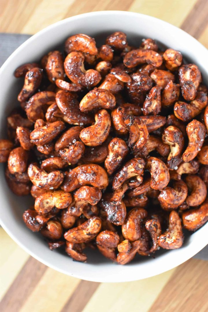 overhead shot of roasted nuts in a white bowl