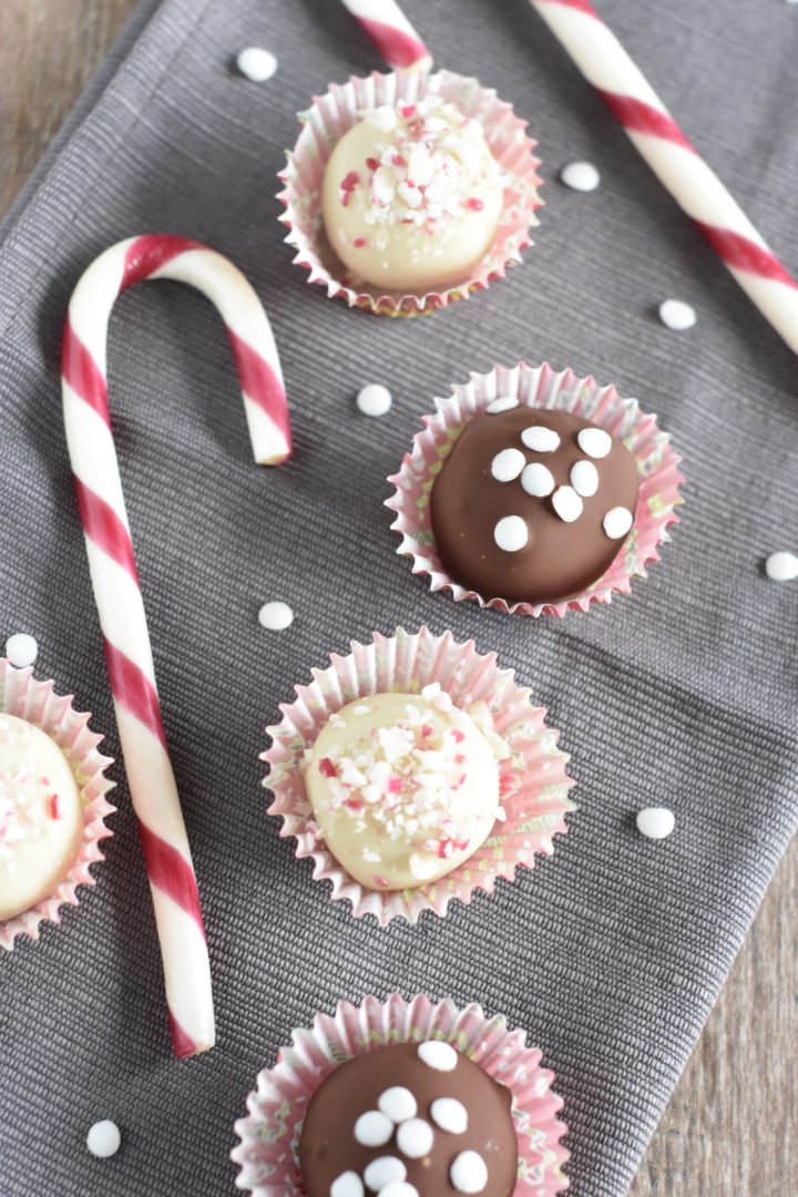 Truffles on a kitchen napkin with sequin sprinkles and candy canes around them