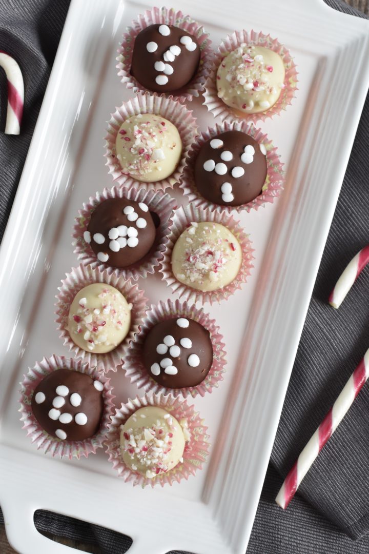 sugar cookie truffles on white serving platter alternating dark and white chocolate flavors