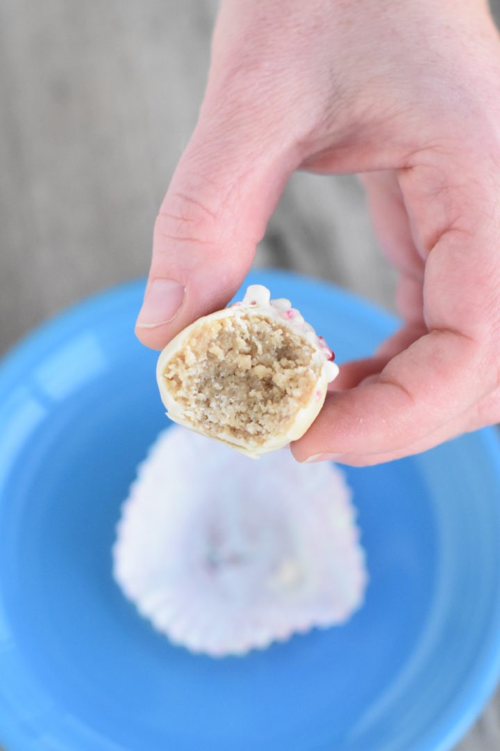 Hand holding an open truffle to show the inside