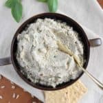 overhead of ricotta in a bowl with a cheese knife in it