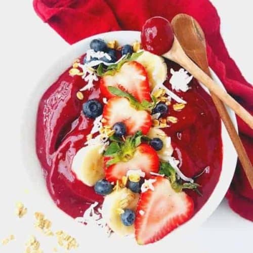 overhead of acai bowl with fruit on top.