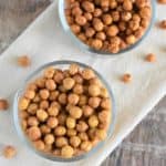 overhead of two flavors of chickpeas in glass bowls on a kitchen towel