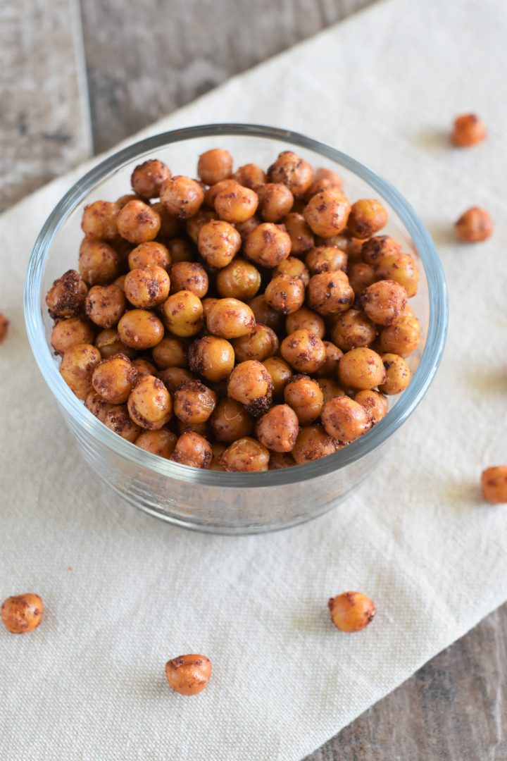 BBQ chickpeas in bowl on kitchen towel with some on the towel