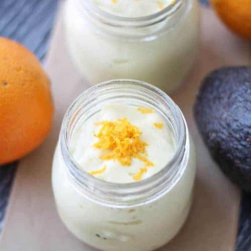 overhead shot of two orange avocado smoothies.