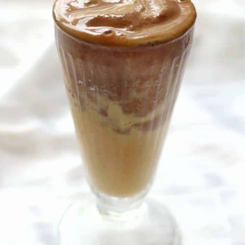 peanut butter cup protein smoothie in a sundae glass.