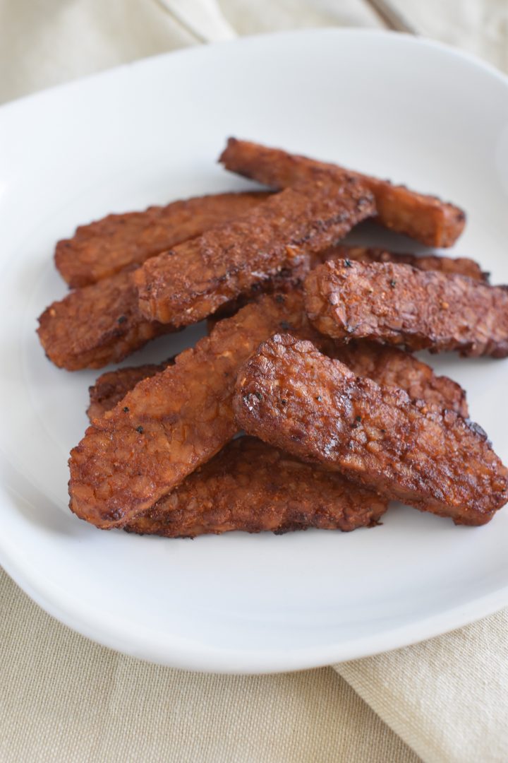 tempeh on a white plate on a kitchen napkin