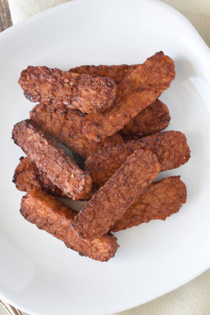 Overhead of tempeh on white plate