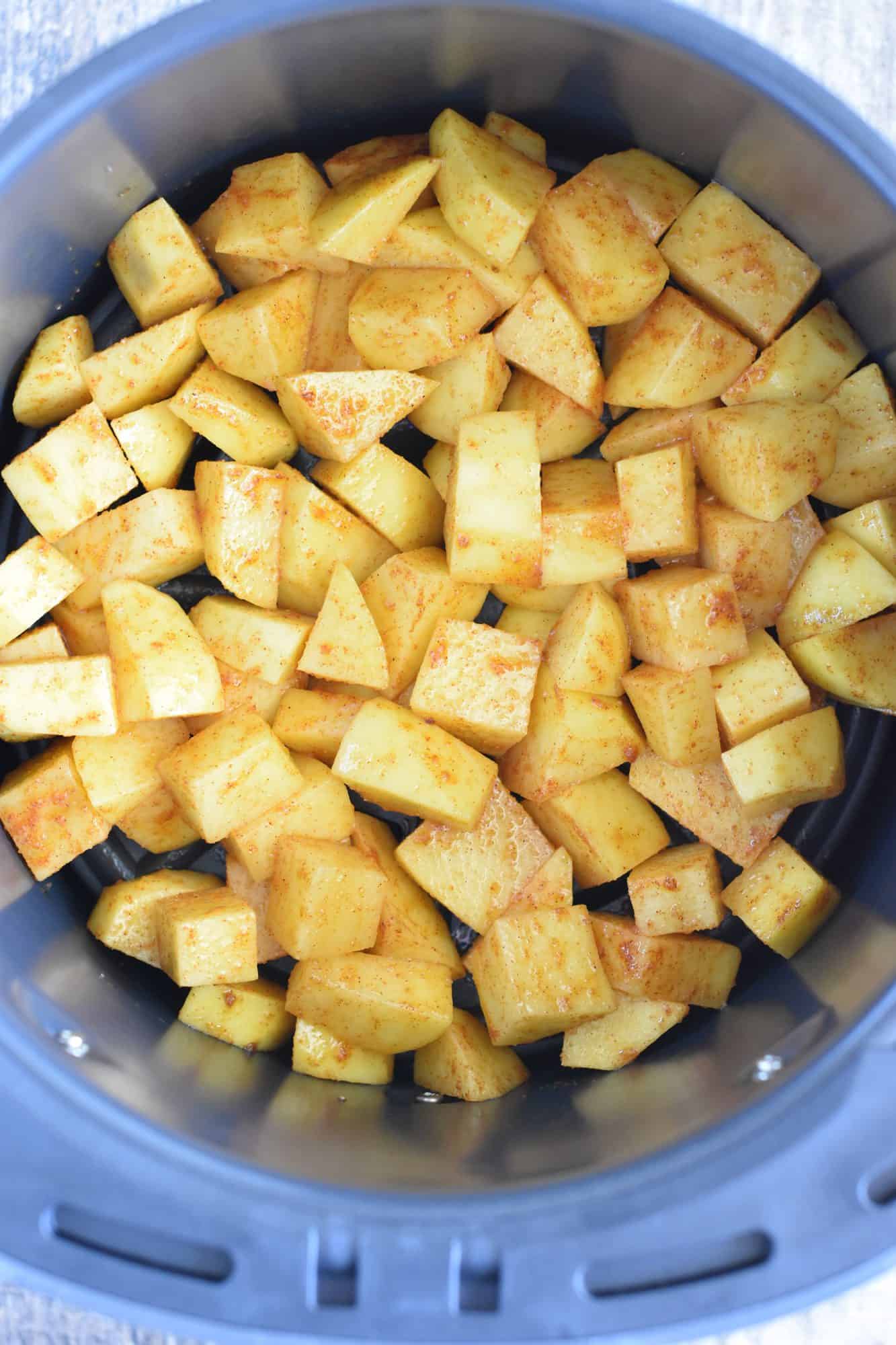 potatoes added to the air fryer before cooking