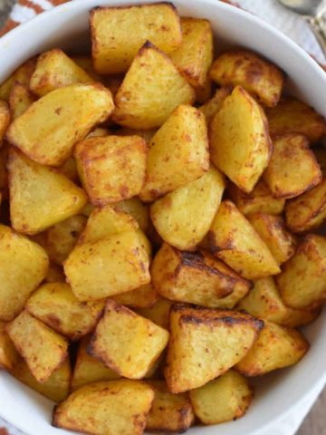 overhead of breakfast potatoes in a white bowl