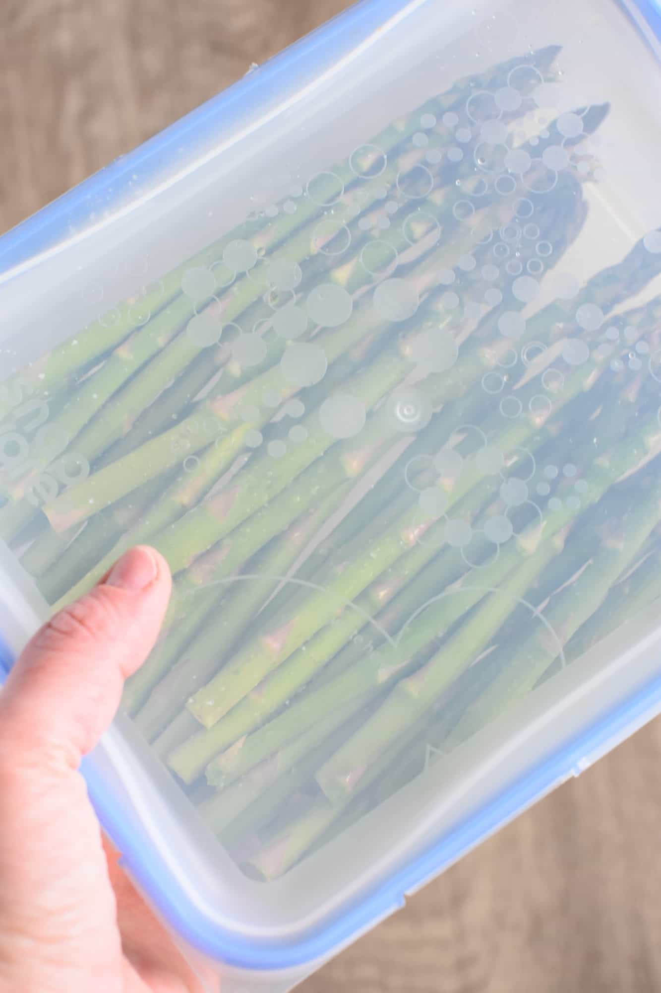 Shaking the container of asparagus