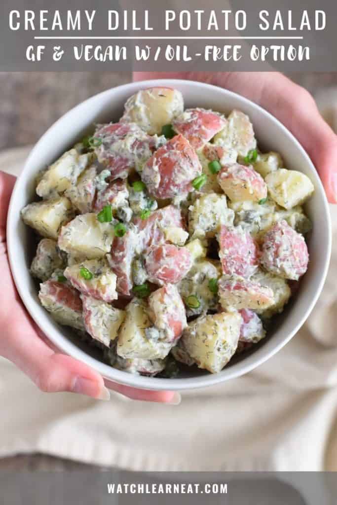 pin showing hands holding up bowl of dill potato salad