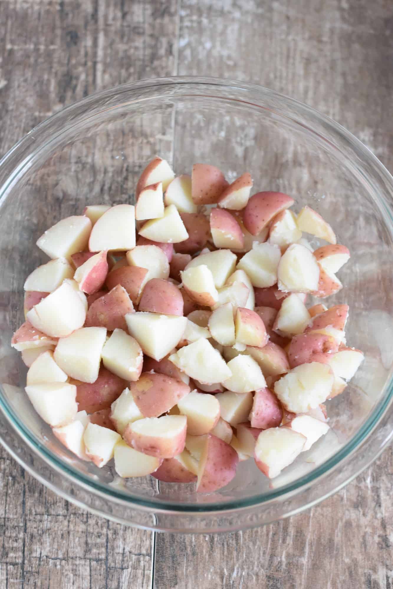 cooked and cooled potatoes added to glass mixing bowl