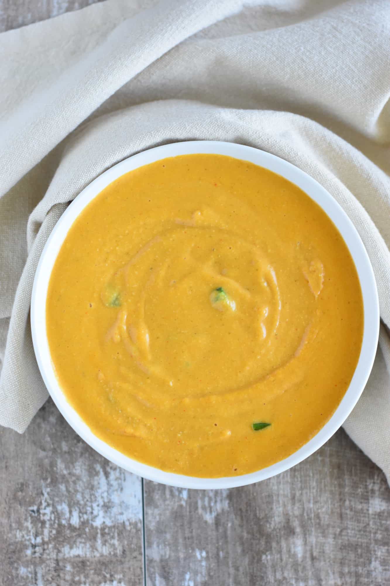 jalapeno stirred into the sauce in a white bowl