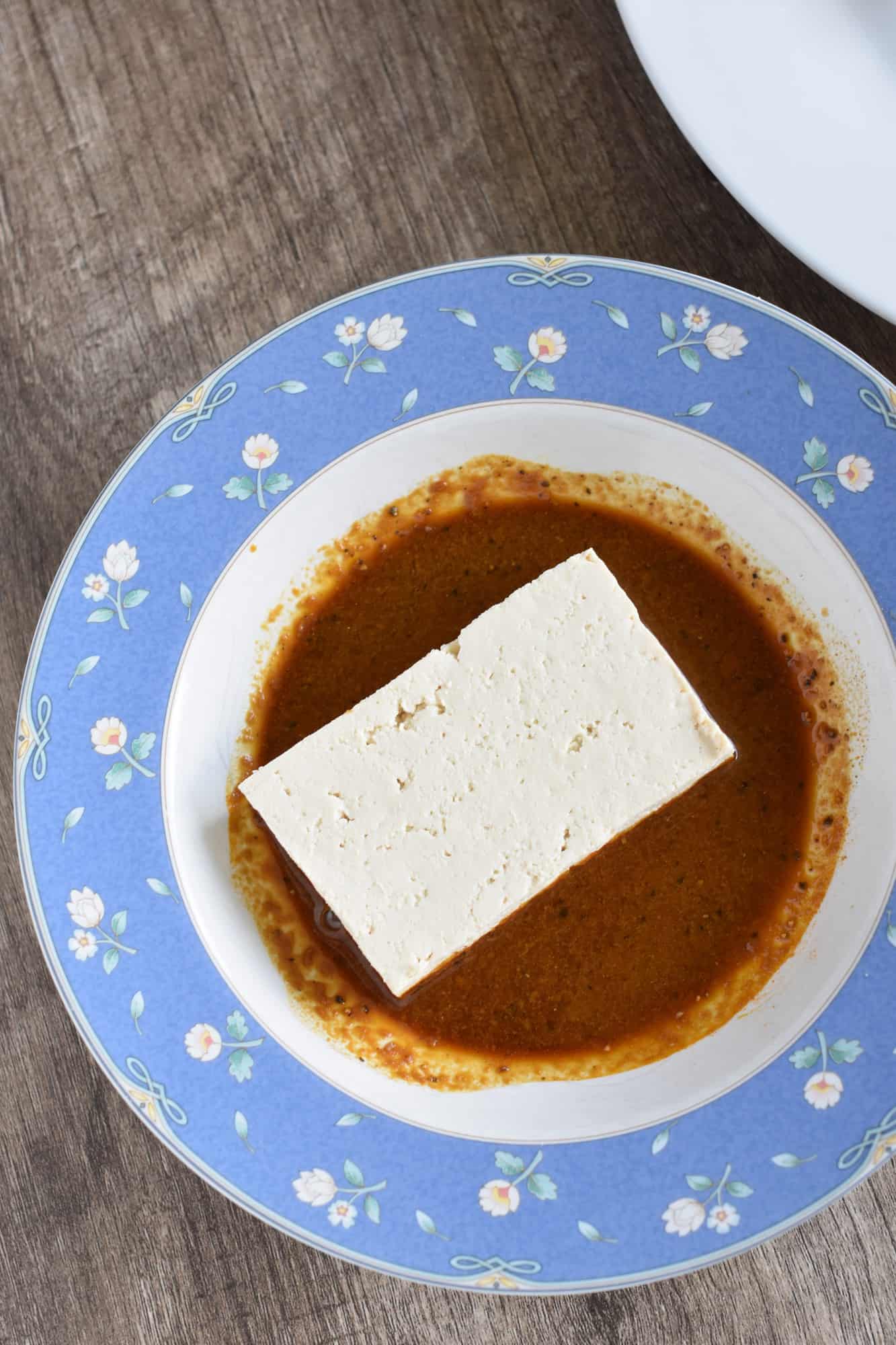 tofu piece in the bowl of coating