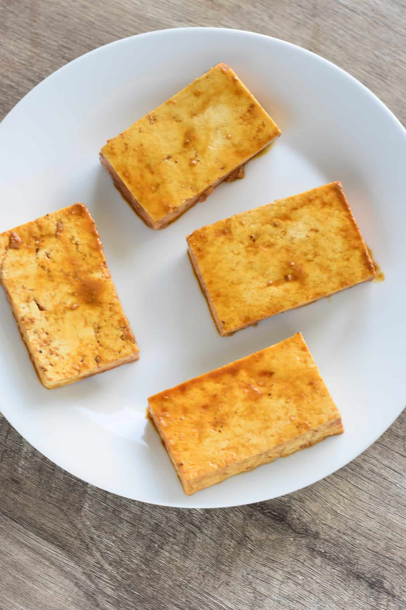 coated tofu pieces on a white plate