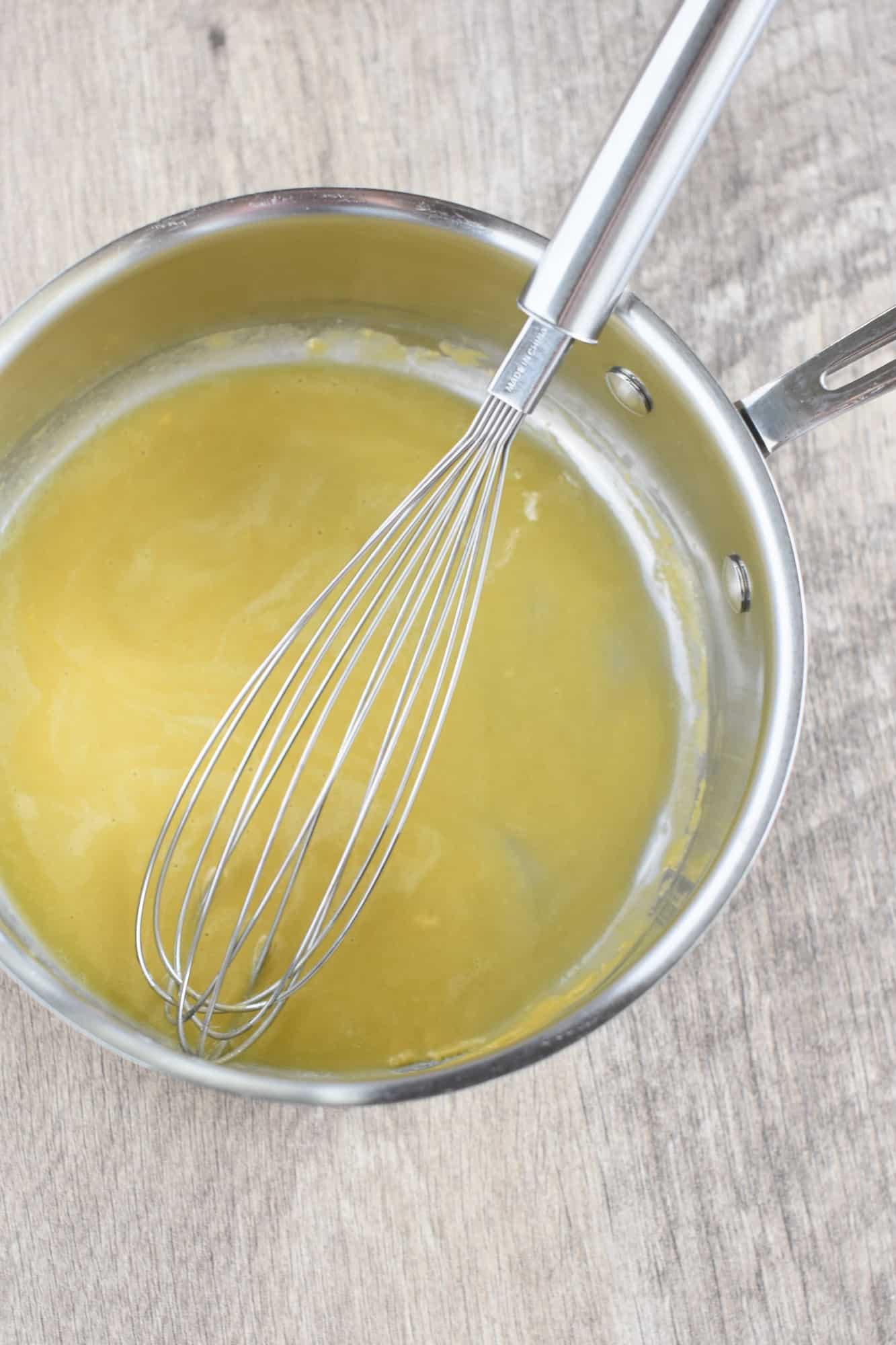 whisking the roux for the bechamel in a saucepan