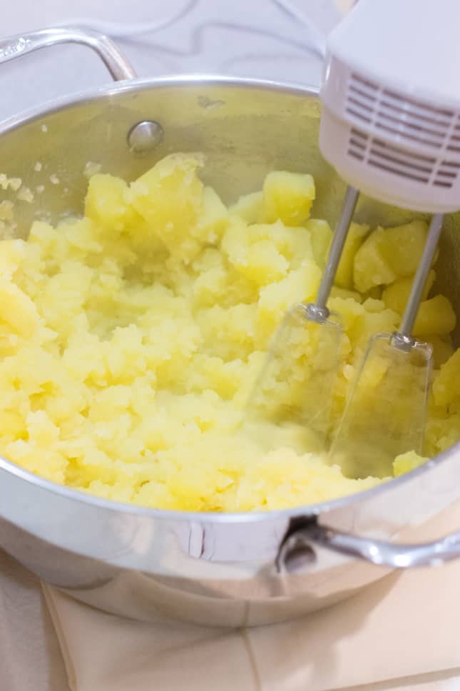 whipping potatoes with an electric mixer